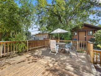 Enjoy outdoor living on this spacious wooden deck, perfect for entertaining or relaxing.