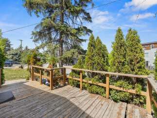 Enjoy outdoor living on this spacious wooden deck, perfect for entertaining or relaxing.
