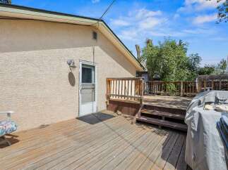Enjoy outdoor living on this spacious wooden deck, perfect for entertaining or relaxing.