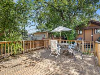 Enjoy outdoor living on this spacious wooden deck, perfect for entertaining or relaxing.