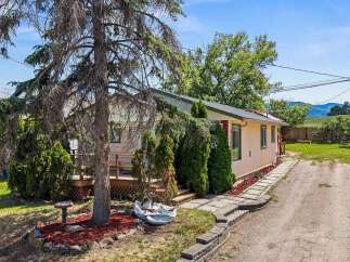 Discover this charming home featuring a welcoming deck perfect for outdoor relaxation and a well-maintained yard with mature trees.