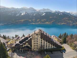 Experience breathtaking panoramic views of snow-capped mountains and a serene lake from this stunning property.