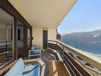 Enjoy breathtaking mountain and lake views from this stunning balcony, perfect for relaxing or entertaining.
