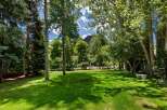 Enjoy the serene beauty of this lush green lawn, perfect for outdoor activities and relaxation.