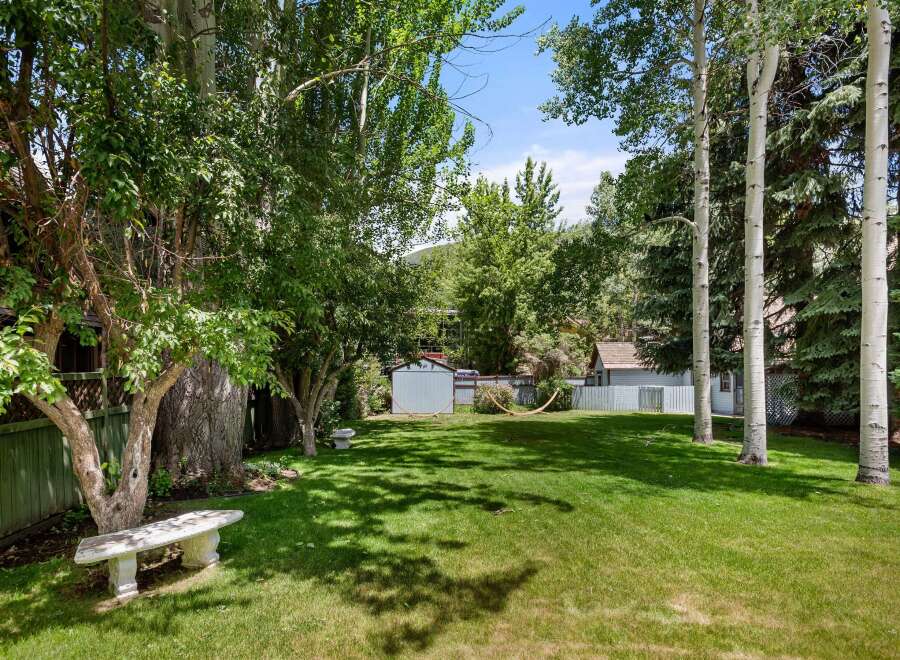 Enjoy the lush green backyard of this property, perfect for outdoor relaxation and recreation.