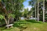 Enjoy the lush green backyard of this property, perfect for outdoor relaxation and recreation.