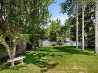 Enjoy the lush green backyard of this property, perfect for outdoor relaxation and recreation.