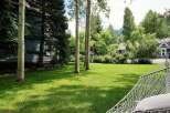 Enjoy the serene beauty of this property, featuring a lush green lawn perfect for outdoor activities and relaxation.