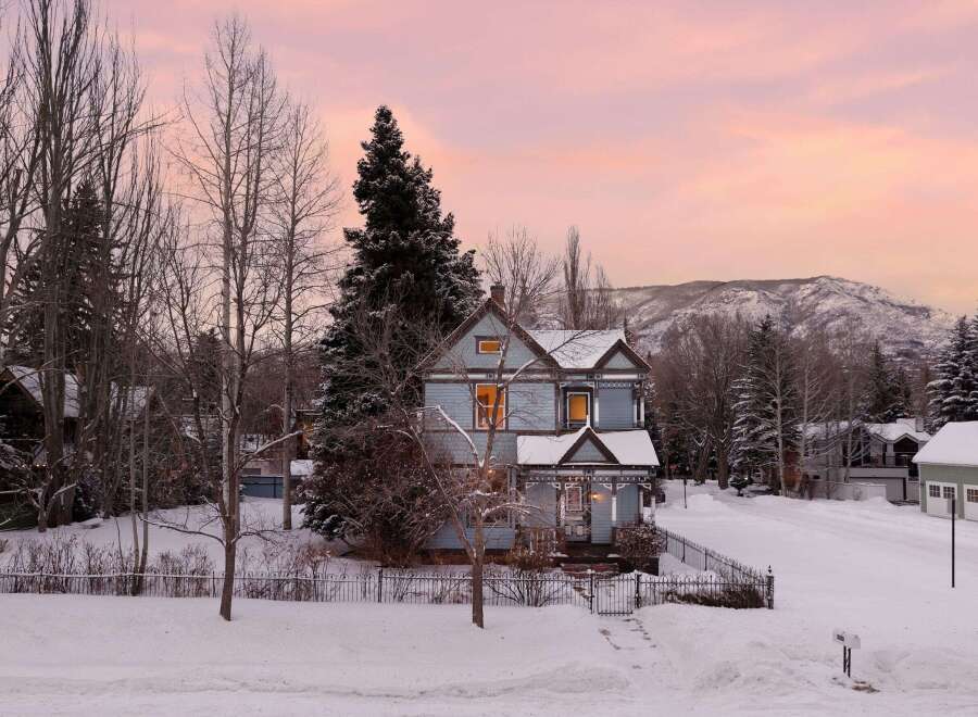 Experience the charm of this historic Victorian home nestled in a picturesque winter wonderland.