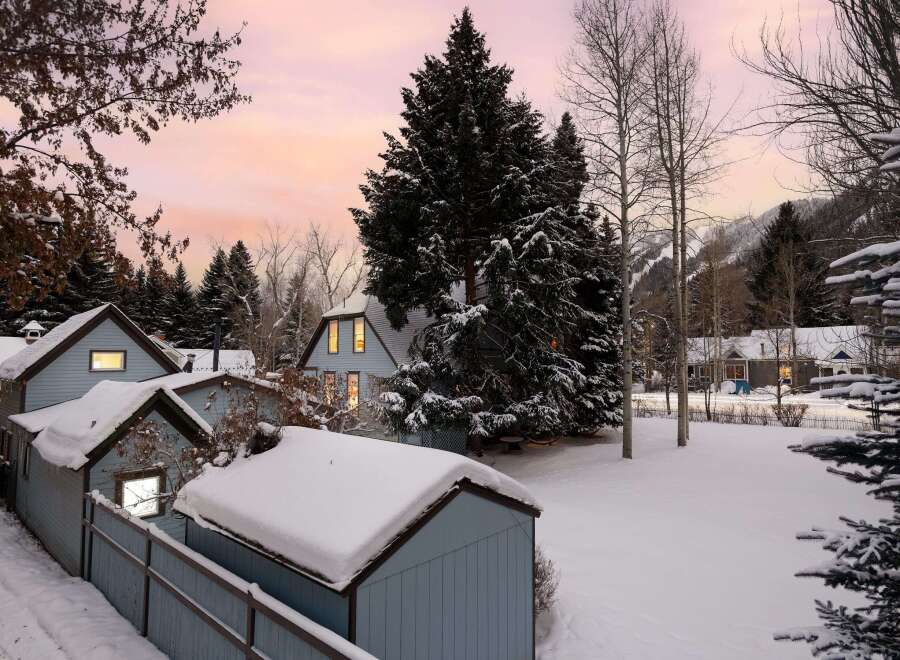 Experience the magic of winter with this charming property nestled amidst snow-covered trees and mountains.