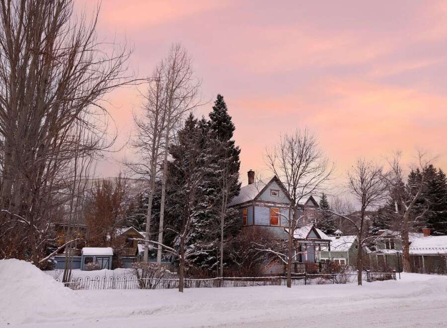 Charming historic homes nestled in a serene, snow-covered landscape.