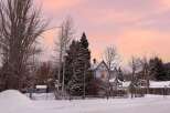 Charming historic homes nestled in a serene, snow-covered landscape.
