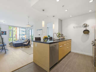 Experience modern living in this bright and airy condo, featuring an open-concept layout that seamlessly connects the living room and kitchen.