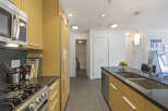 This modern kitchen boasts sleek, light wood cabinetry and a durable granite countertop.