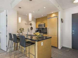 Discover modern living in this sleek kitchen featuring a spacious island with bar seating, perfect for casual dining and entertaining.
