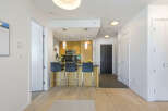 Experience modern living in this stylish condo featuring a sleek kitchen with a breakfast bar and stainless steel appliances.