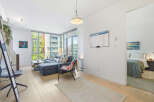 Experience modern living in this bright and airy condo featuring a spacious living area with ample natural light from floor-to-ceiling windows.