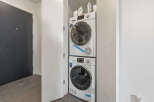 Discover modern convenience with this stacked washer and dryer unit, perfect for maximizing space in your laundry area.