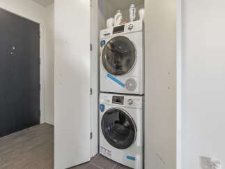 Discover modern convenience with this stacked washer and dryer unit, perfect for maximizing space in your laundry area.