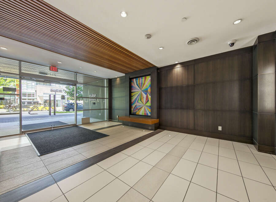 Step into a modern and inviting lobby featuring a striking piece of abstract art that adds a vibrant splash of color.