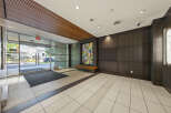 Step into a modern and inviting lobby featuring a striking piece of abstract art that adds a vibrant splash of color.