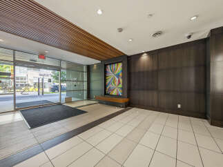 Step into a modern and inviting lobby featuring a striking piece of abstract art that adds a vibrant splash of color.