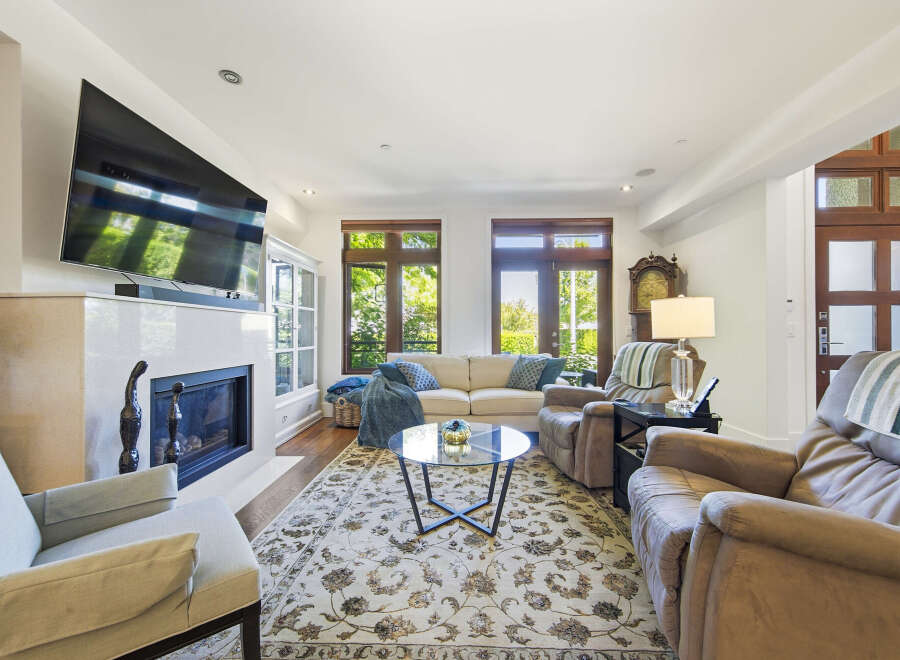 Experience comfort and style in this inviting living room, featuring a modern fireplace and a large flat-screen TV perfect for entertainment.