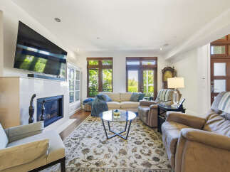 Experience comfort and style in this inviting living room, featuring a modern fireplace and a large flat-screen TV perfect for entertainment.