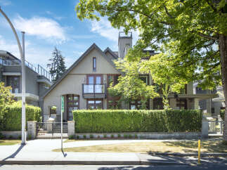 Discover this stunning modern home featuring a striking stucco exterior and a prominent pitched roofline.