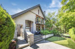 Discover this stunning home featuring a modern stucco exterior and elegant stone accents.