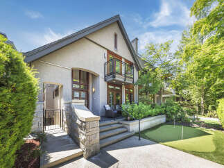 Discover this stunning home featuring a modern stucco exterior and elegant stone accents.
