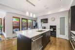 Experience modern living in this stunning kitchen featuring a large island with a double sink and sleek cabinetry.