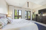 Experience luxury and comfort in this master bedroom, featuring a king-size bed with floral bedding and plush pillows.