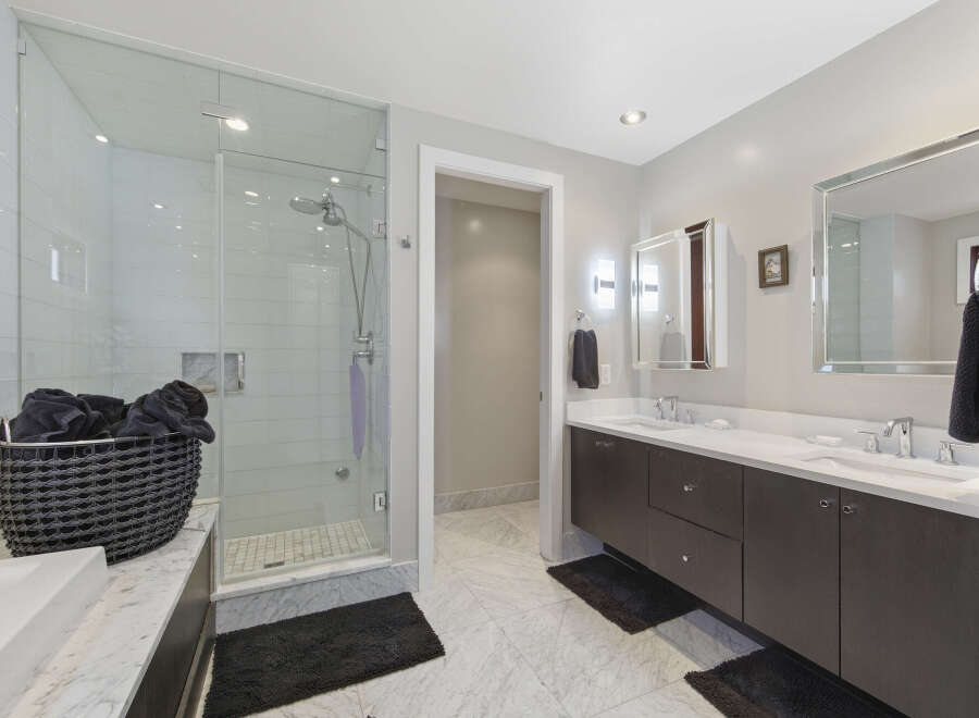 Experience luxury in this modern bathroom featuring a spacious glass-enclosed shower with sleek tilework.