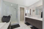 Experience luxury in this modern bathroom featuring a spacious glass-enclosed shower with sleek tilework.