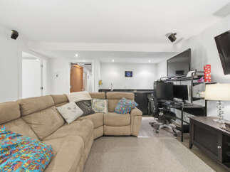 This basement living area offers a comfortable and functional space for relaxation and entertainment.