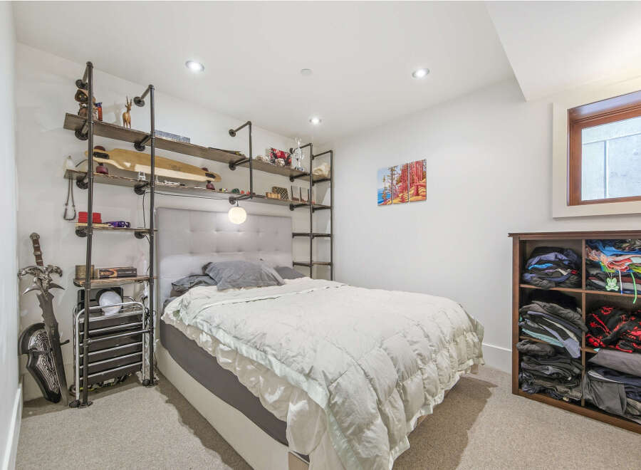 Discover this cozy bedroom featuring a stylish upholstered headboard and a plush duvet for ultimate comfort.