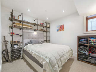 Discover this cozy bedroom featuring a stylish upholstered headboard and a plush duvet for ultimate comfort.