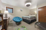 Discover comfort and style in this inviting bedroom, featuring a plush blue papasan chair perfect for relaxation.
