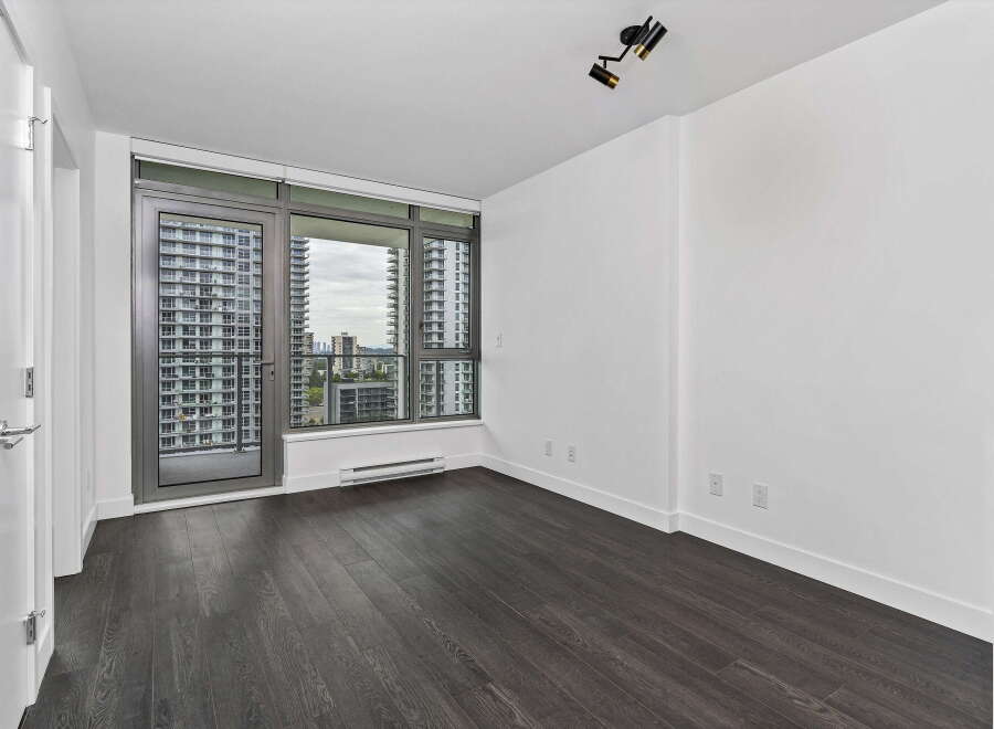 Experience modern living in this spacious apartment featuring expansive floor-to-ceiling windows that flood the space with natural light.