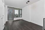 Experience modern living in this spacious apartment featuring expansive floor-to-ceiling windows that flood the space with natural light.