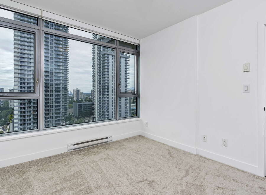 Experience breathtaking city views from this spacious room, featuring expansive windows that flood the space with natural light.