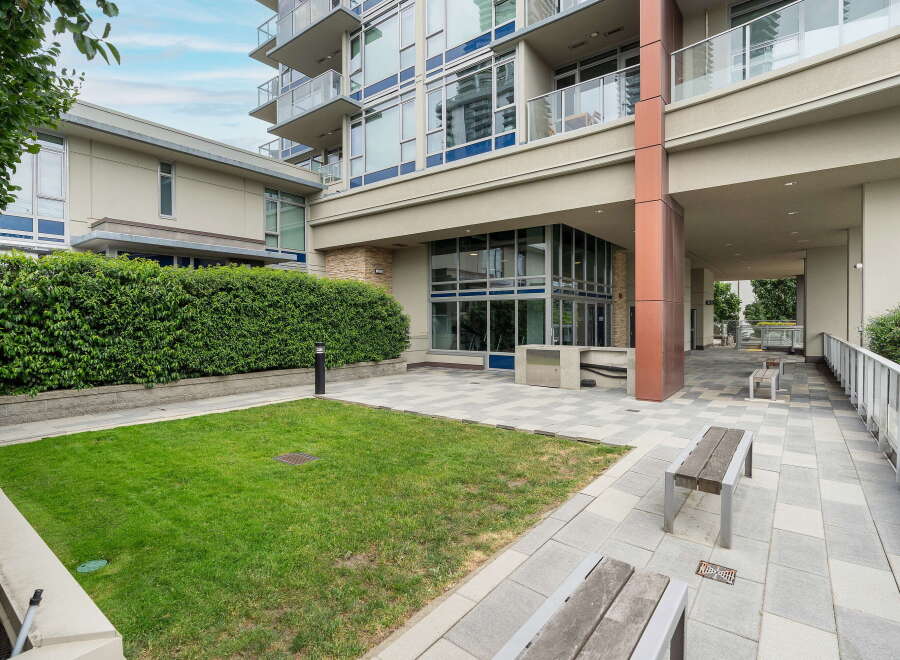 Discover modern urban living with this stunning property featuring a manicured lawn and elegant paved walkways.