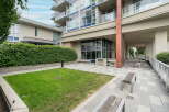 Discover modern urban living with this stunning property featuring a manicured lawn and elegant paved walkways.