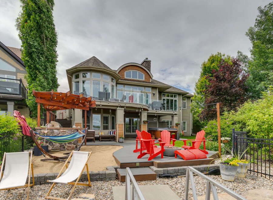Experience luxurious lakeside living with this stunning property featuring a spacious backyard perfect for entertaining.