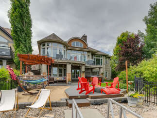 Experience luxurious lakeside living with this stunning property featuring a spacious backyard perfect for entertaining.