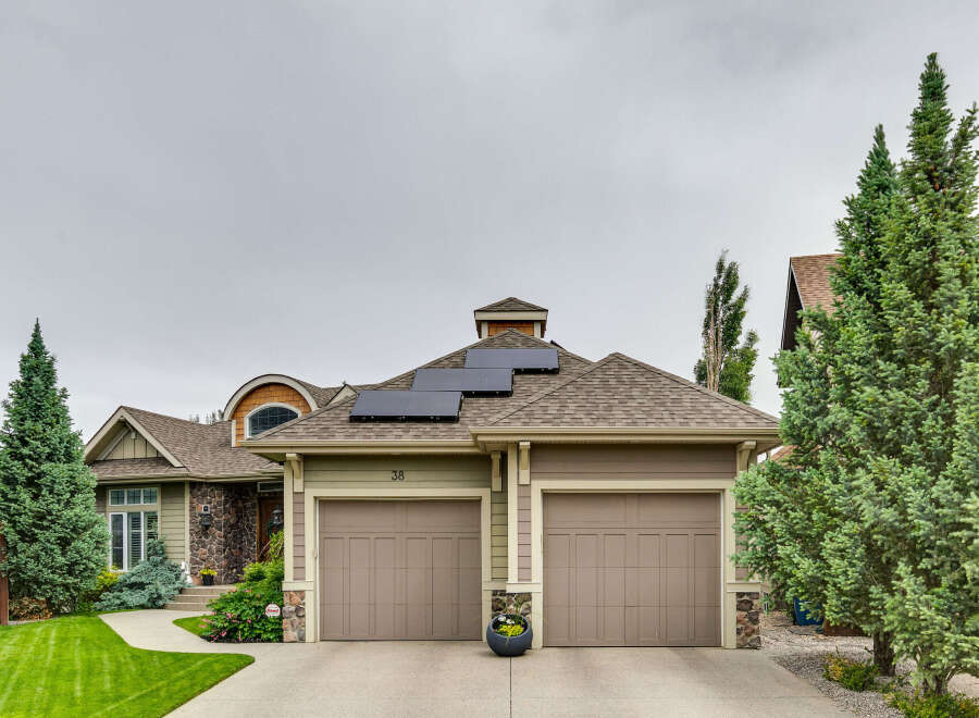 This charming home features a modern aesthetic with solar panels on the roof, perfect for sustainable living.