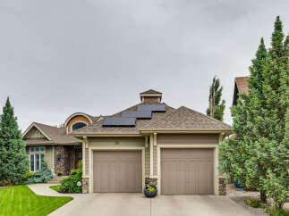 This charming home features a modern aesthetic with solar panels on the roof, perfect for sustainable living.