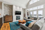Experience luxury living in this stunning home featuring a modern living room with a stone accent wall and a sleek fireplace.