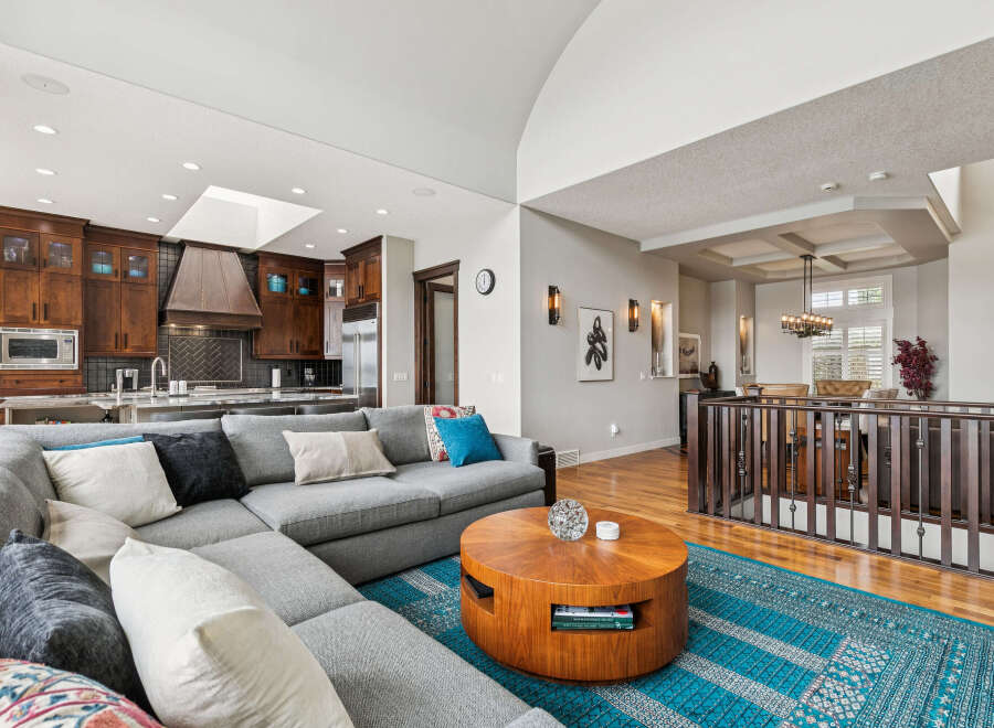 Experience luxury living in this stunning open-concept home, featuring a gourmet kitchen with rich wood cabinetry and a spacious living area perfect for entertaining.
